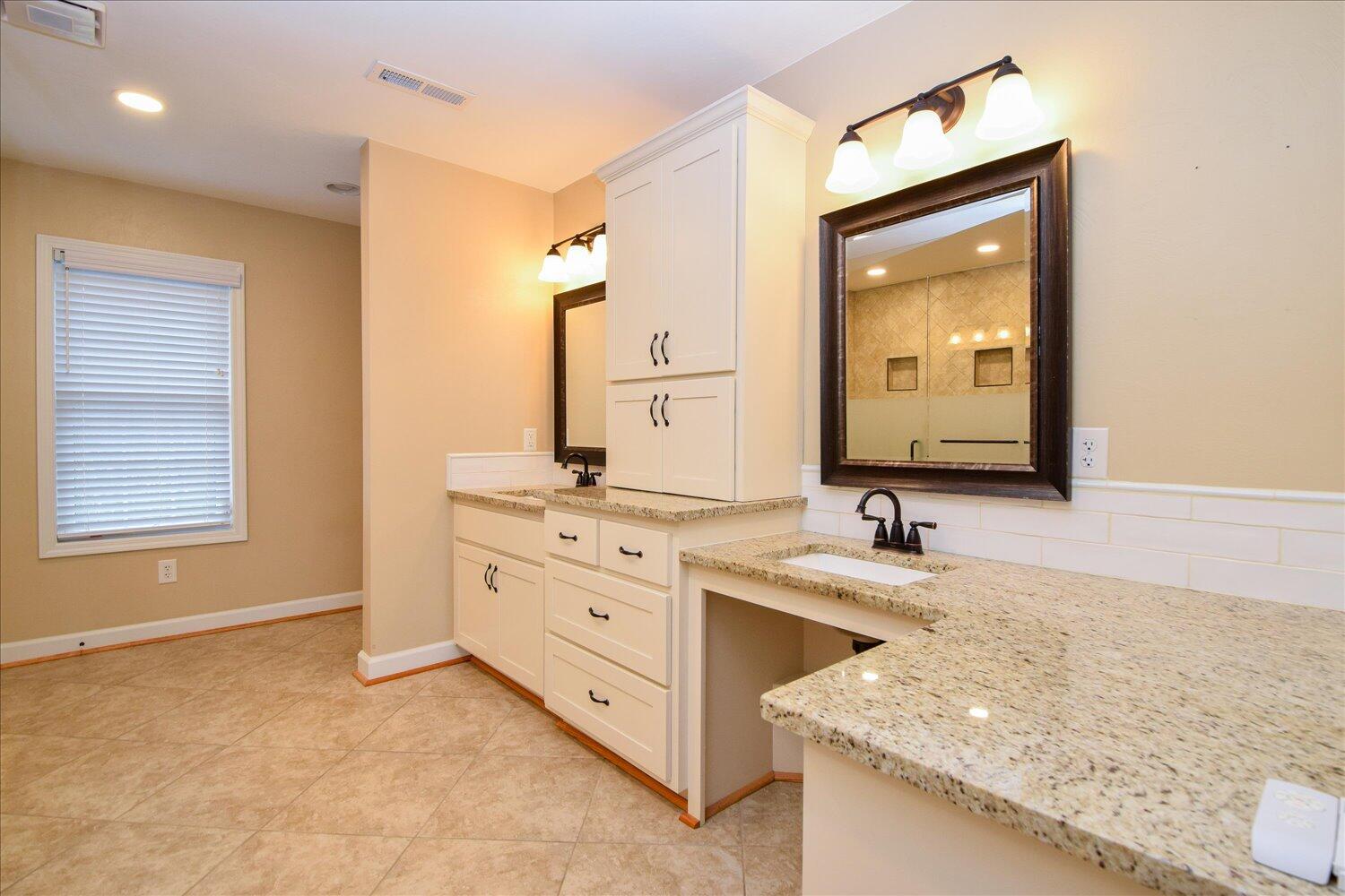 5515 Breckinridge Mill Road Fincastle, VA 24090 - Photo 13 of 31 a bathroom with a granite countertop double vanity sink and mirror