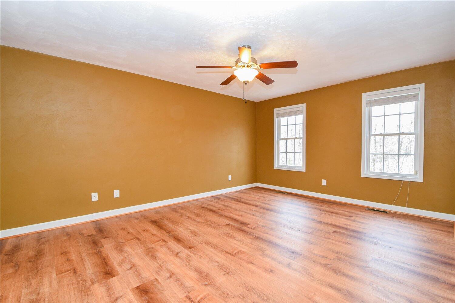 5515 Breckinridge Mill Road Fincastle, VA 24090 - Photo 18 of 31 a view of an empty room with window and chandelier fan