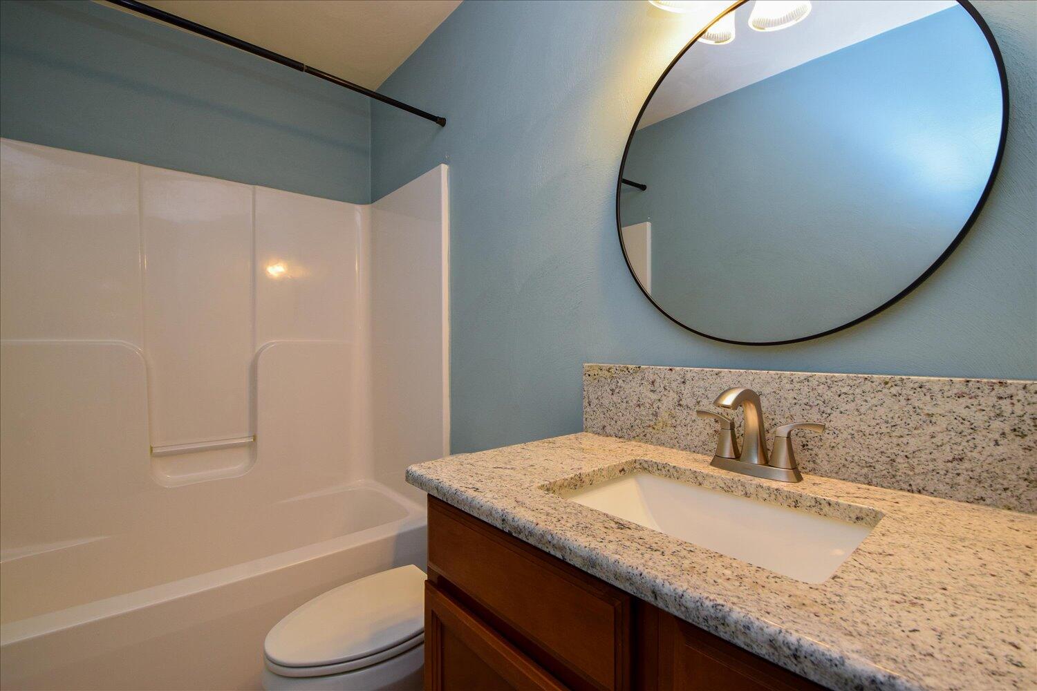 5515 Breckinridge Mill Road Fincastle, VA 24090 - Photo 24 of 31 a bathroom with a granite countertop sink and a mirror