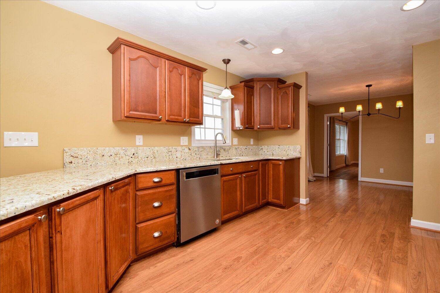 5515 Breckinridge Mill Road Fincastle, VA 24090 - Photo 9 of 31 a kitchen with stainless steel appliances granite countertop wooden cabinets a sink and dishwasher with wooden floor