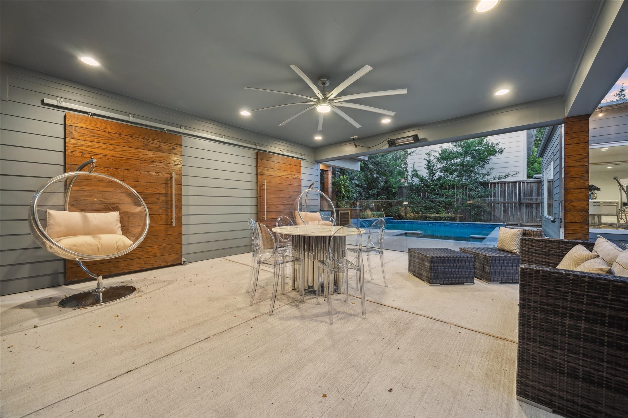 2420 Locke Lane Houston, TX 77019 - Photo 30 of 37 This space under the carport is great for entertaining. Plenty of space for sitting/dining furniture with great views of the pool. The fan and heater provide allow usage year round. Behind the two sliding doors is a large storage closet.