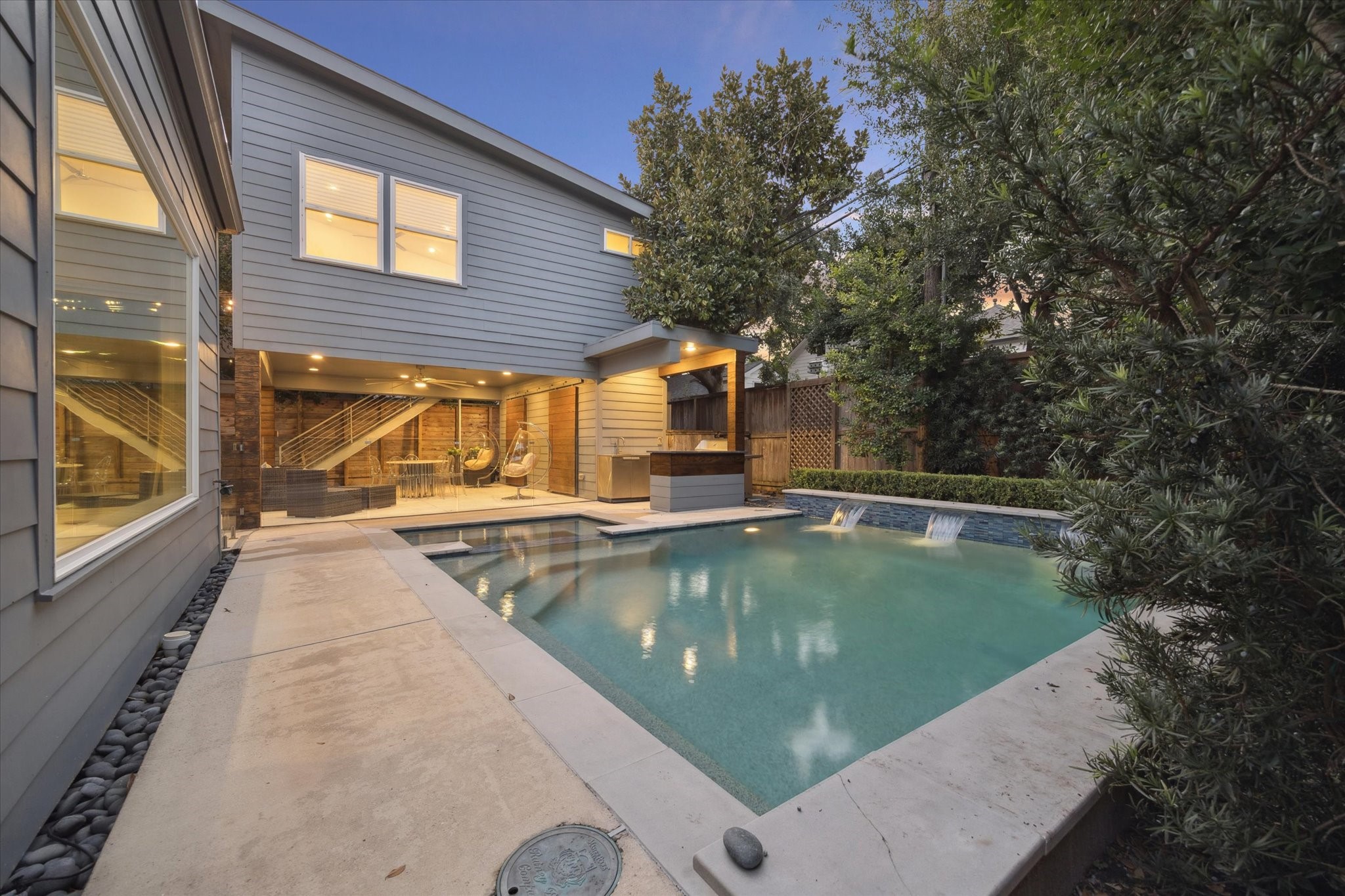 2420 Locke Lane Houston, TX 77019 - Photo 33 of 37 The backyard features a beautiful pool with waterfalls and hot tub. Plenty of decking provide space for lounge furniture. Quick access to the summer kitchen and covered patio.