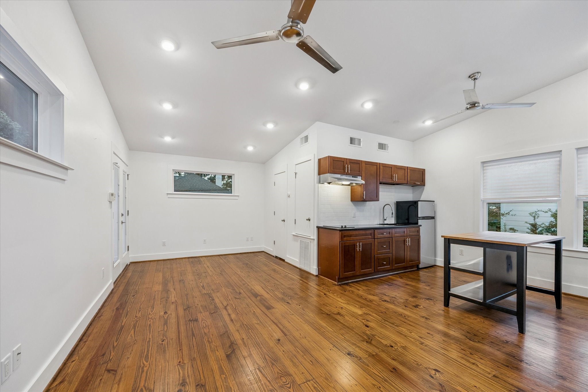 2420 Locke Lane Houston, TX 77019 - Photo 35 of 37 Above the carport is this full apartment which features hardwood floors, kitchen with electric range, sink and fridge with additional space for various configurations of furniture.