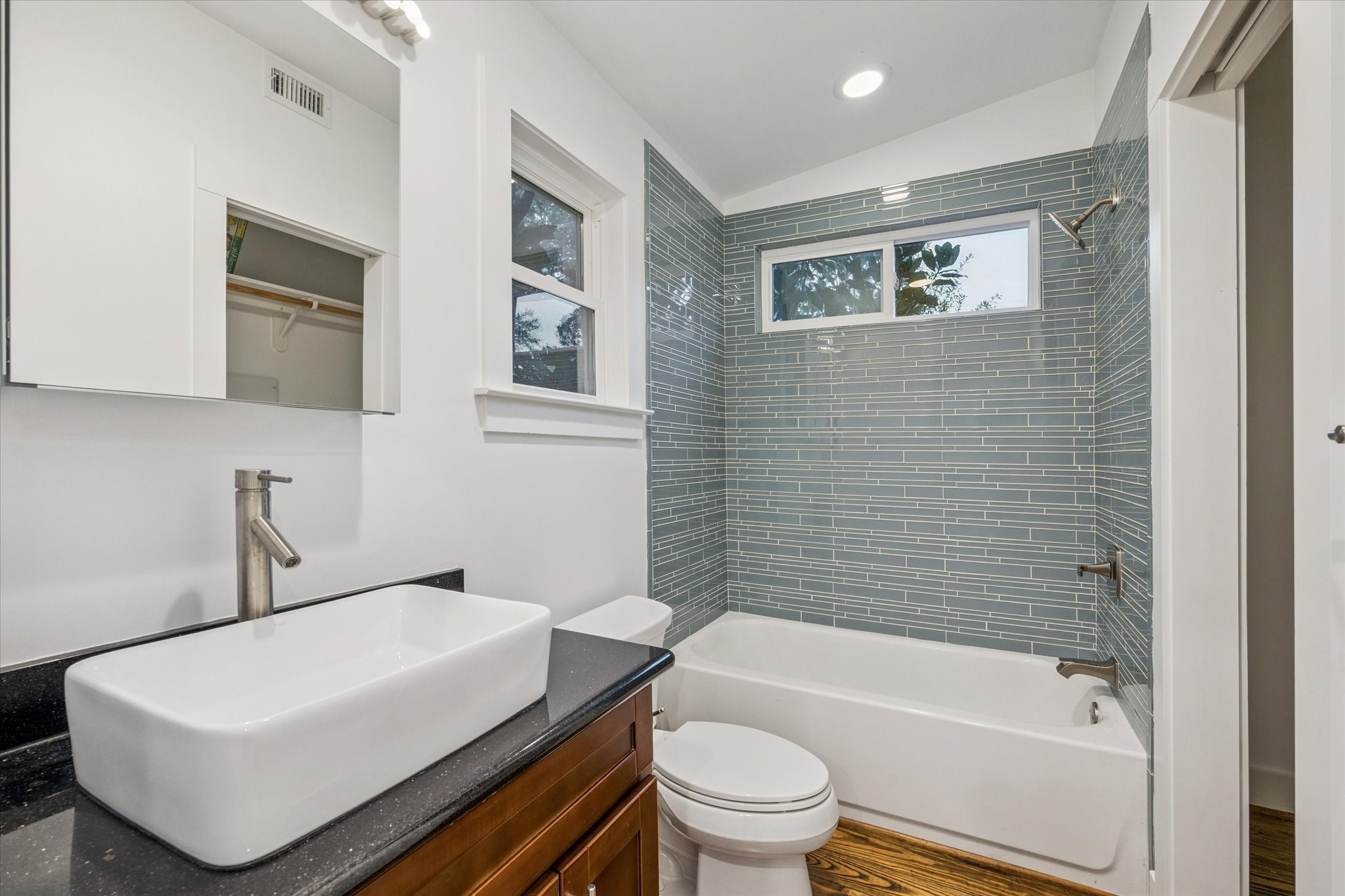 2420 Locke Lane Houston, TX 77019 - Photo 37 of 37 This is the bathroom for the apartment above the carport, which features a vessel sink, tub/shower combo and closet.