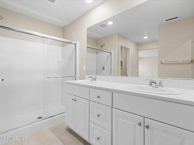 a bathroom with a double vanity sink and mirror
