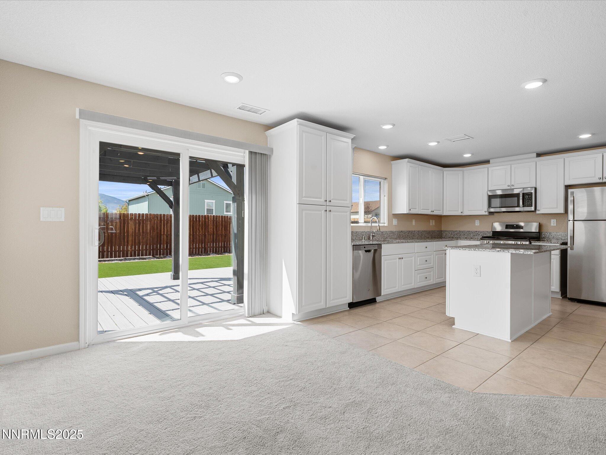 8933 Quail Falls Drive Reno, NV 89506 - Photo 3 of 22 a view of kitchen with stainless steel appliances granite countertop a stove a sink and a refrigerator