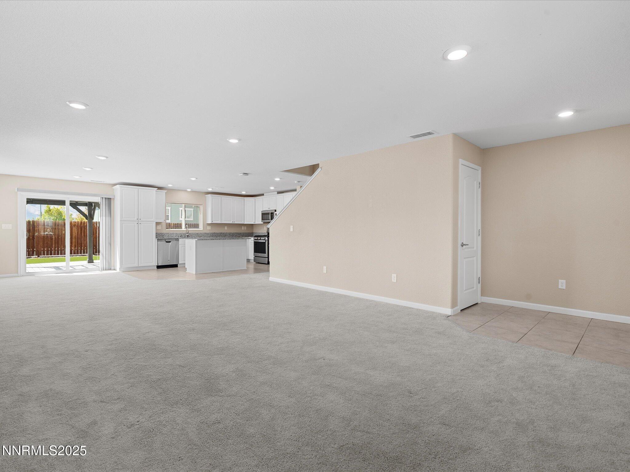 8933 Quail Falls Drive Reno, NV 89506 - Photo 5 of 22 a view of empty room with a kitchen