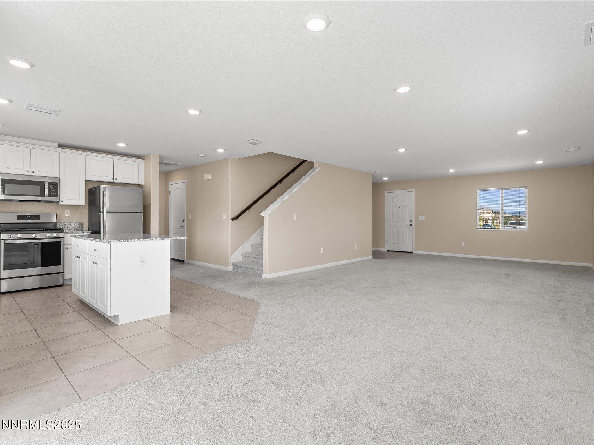 8933 Quail Falls Drive Reno, NV 89506 - Photo 6 of 22 a view of a kitchen with a sink and refrigerator