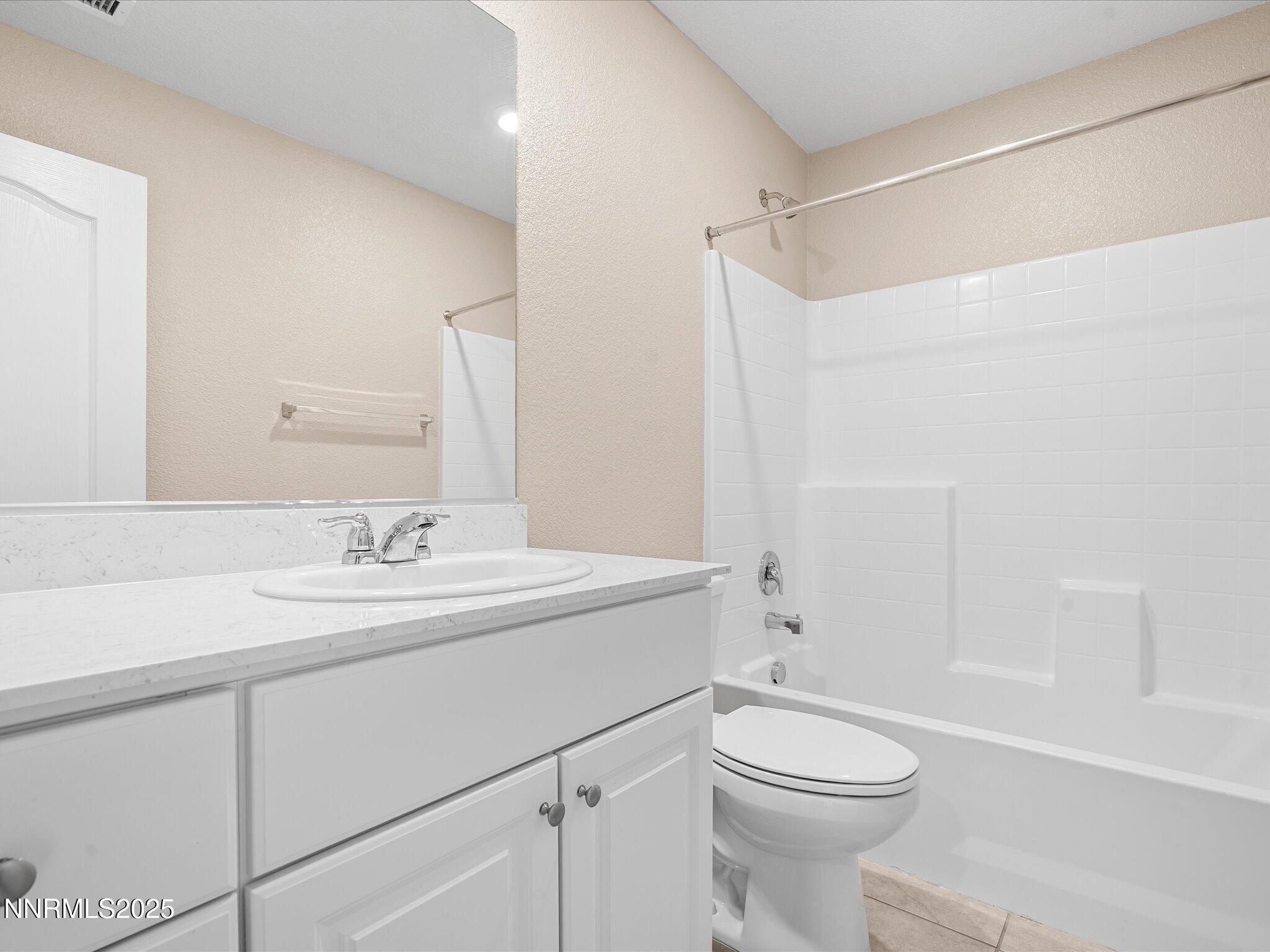8933 Quail Falls Drive Reno, NV 89506 - Photo 10 of 22 a bathroom with a sink a toilet and shower