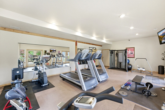 3634 North Huntsman Path, Unit C203 Eden, UT 84310 - Photo 17 of 27 Dedicated fitness area featuring extensive wall mirrors, neutral-toned flooring, recessed lighting, and a built-in multi-gym system