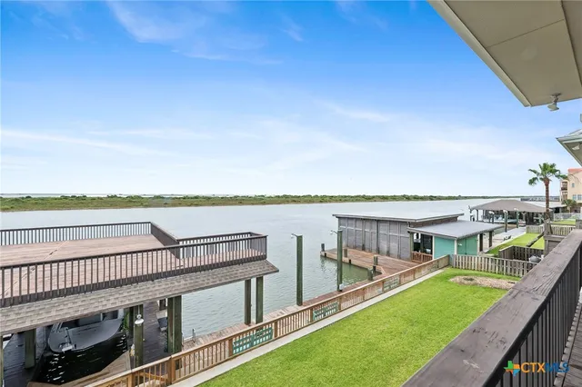 a view of a house with backyard and deck
