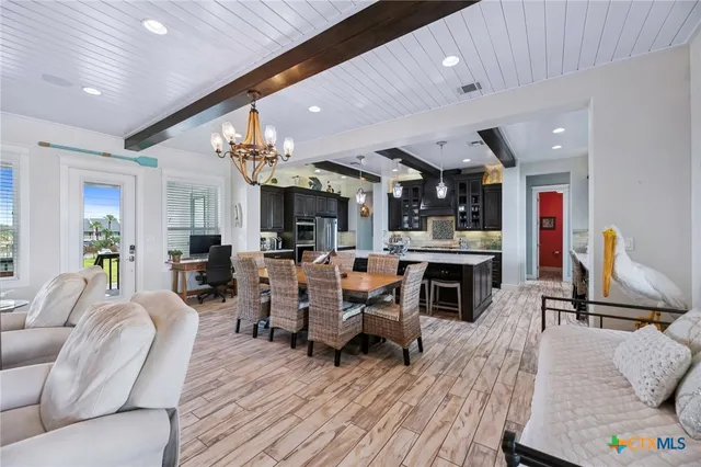 a living room with furniture kitchen view and a fireplace
