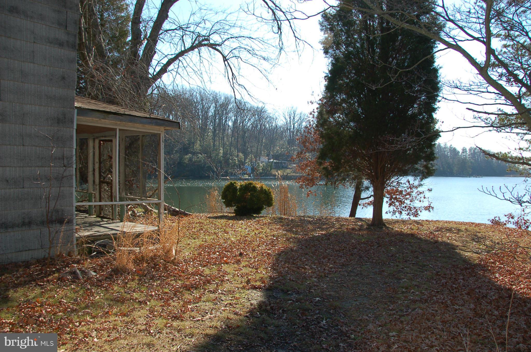 12880 Mccready Road Lusby, MD 20657 - Photo 19 of 30 a backyard of a house with yard and outdoor seating