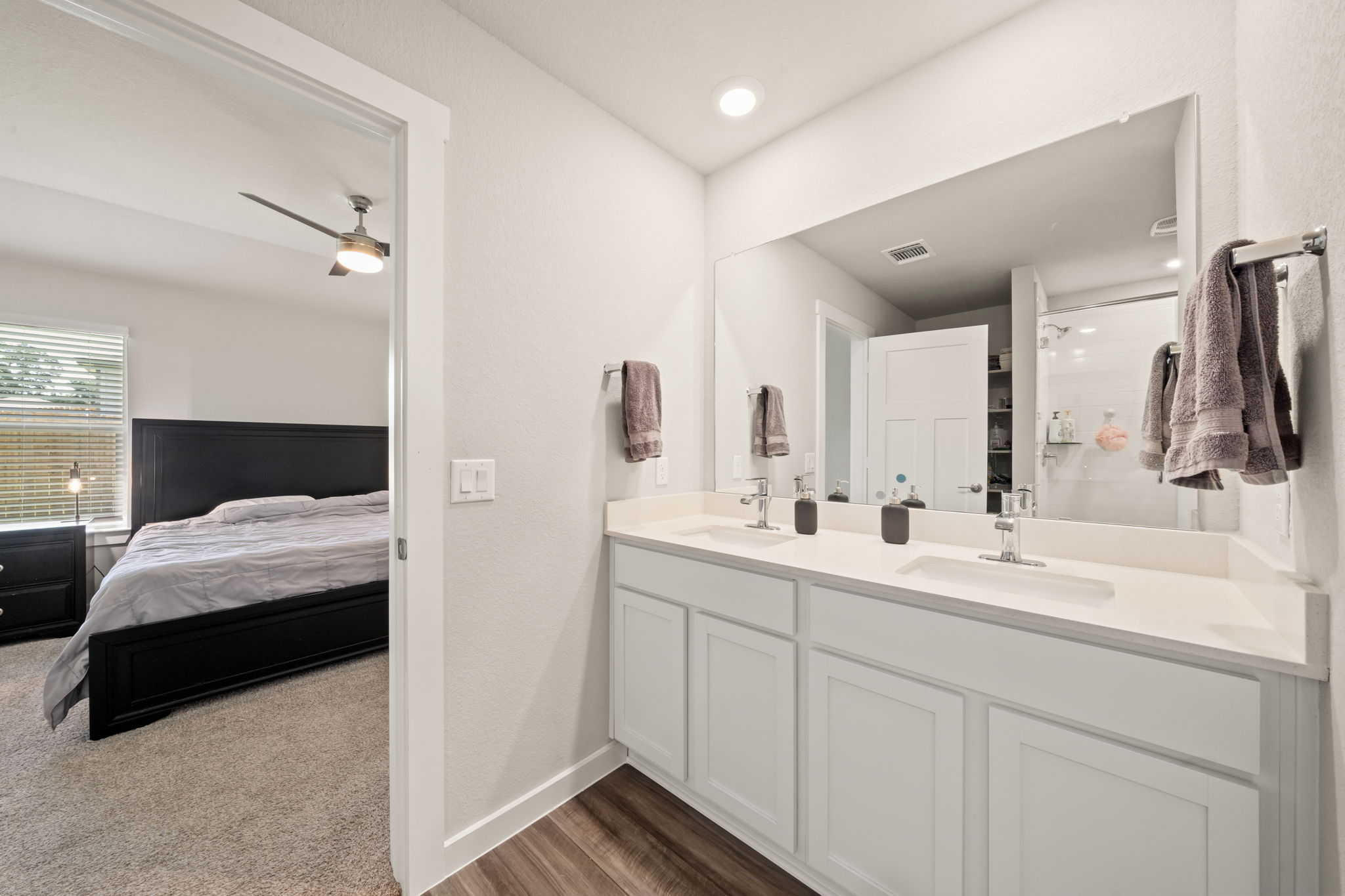 1117 Tipton Street Georgetown, TX 78633 - Photo 22 of 40 Double vanity with white cabinetry, integrated sinks, and chrome faucets