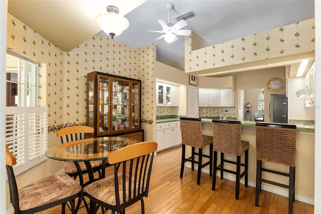 2215 Spring Hill Court Ocala, FL 34471 - Photo 23 of 62 a dining room with furniture a chandelier and wooden floor