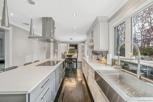 a kitchen with stainless steel appliances a sink stove and cabinets