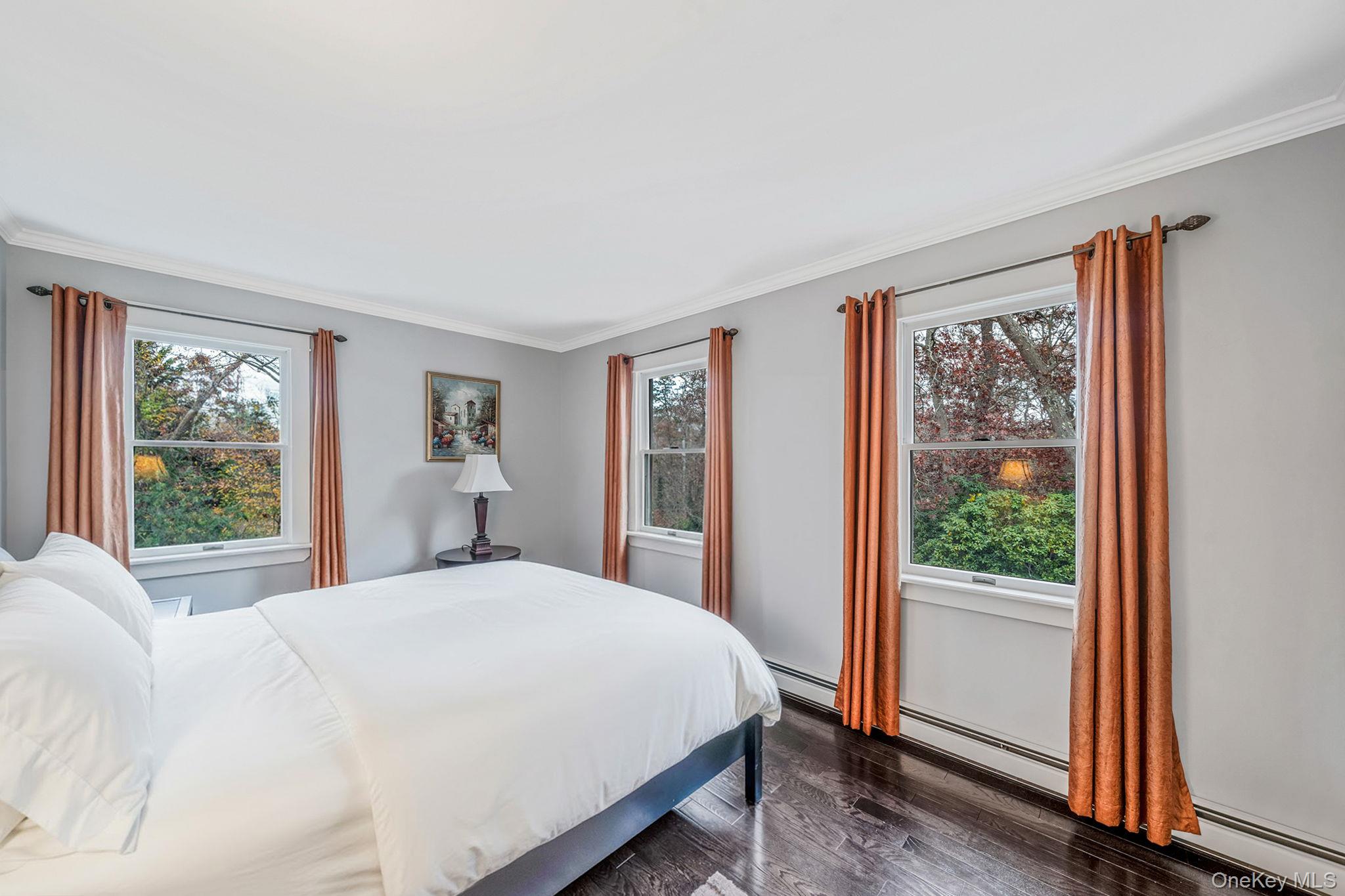 202 Gerard Road Yaphank, NY 11980 - Photo 23 of 42 Bedroom with ornamental molding, dark wood finished floors, and a baseboard radiator