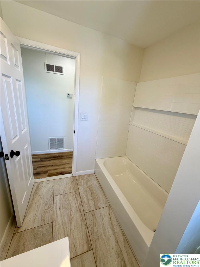 3508 Nazareth Road Easton, PA 18045 - Photo 24 of 25 Fully renovated bathroom with a spacious tub and durable tile flooring, perfect for unwinding.