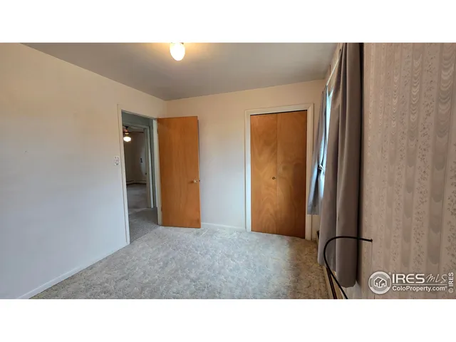 a open living room with a window and a couch