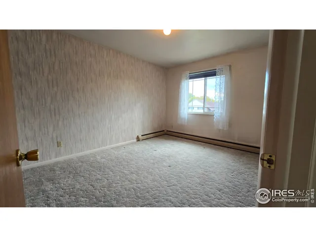 a open area with a cabinet and a mirror