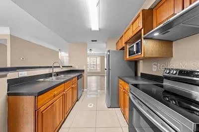 a bathroom with a sink a toilet and a large mirror