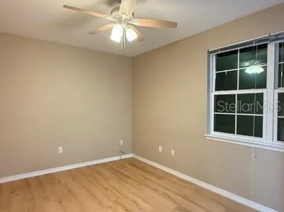 a view of a hallway with wooden floor and entryway
