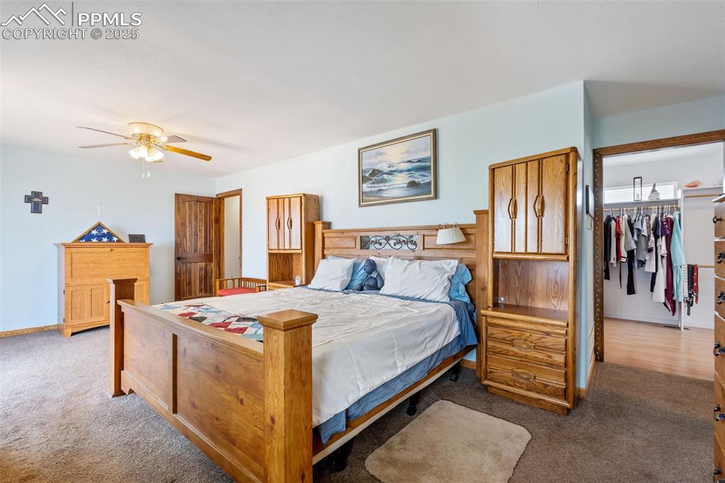 18895 Sage Crest Road Peyton, CO 80831 - Photo 10 of 38 a bedroom with a bed and a refrigerator