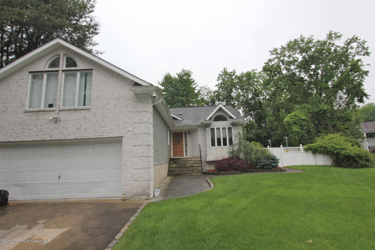 21 Jumping Brook Road Neptune Township, NJ 07753 - Photo 1 of 20 a front view of house with yard and green space