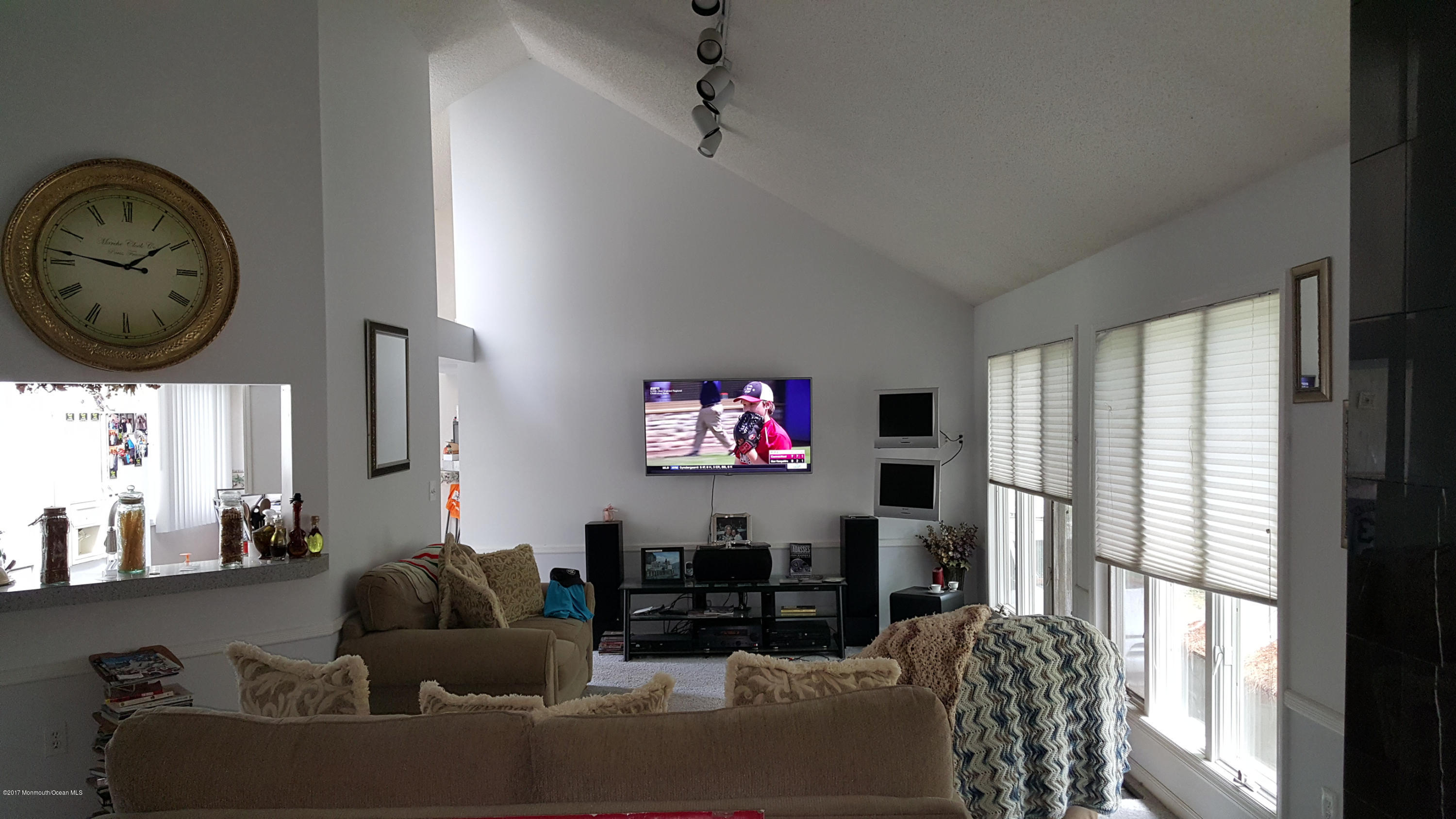 21 Jumping Brook Road Neptune Township, NJ 07753 - Photo 11 of 20 a living room with furniture a large window and a clock