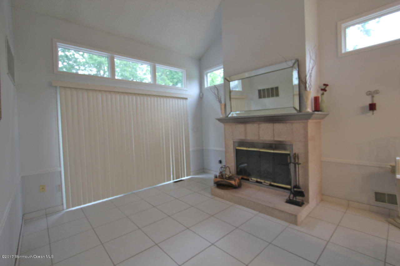21 Jumping Brook Road Neptune Township, NJ 07753 - Photo 5 of 20 a view of an empty room with a fireplace and a window