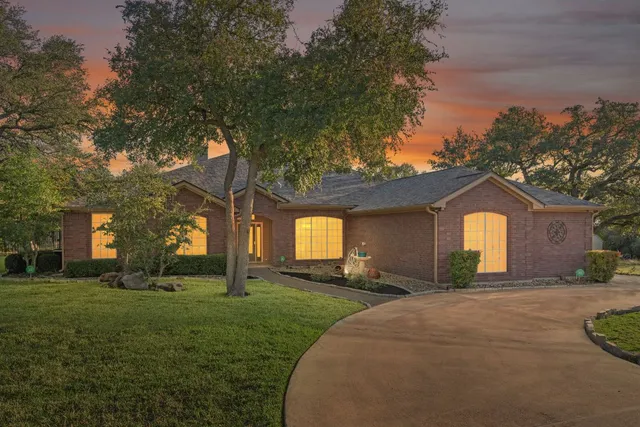 a large house with a big yard and large trees