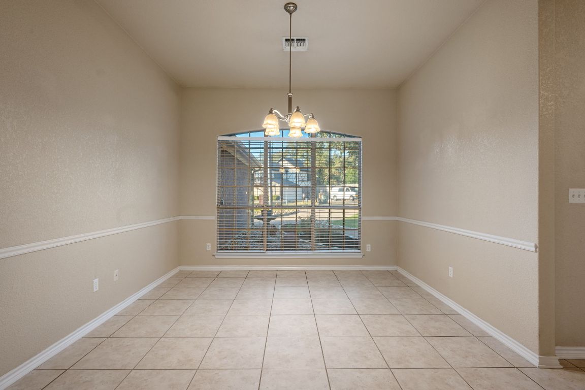 686 Benchmark Trail Belton, TX 76513 - Photo 11 of 38 a view of a room with windows and chandelier