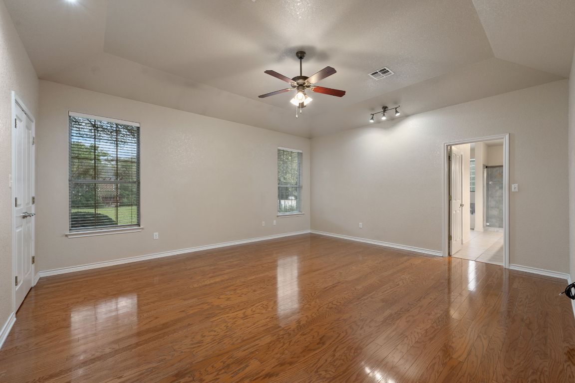 686 Benchmark Trail Belton, TX 76513 - Photo 12 of 38 wooden floor in an empty room with a window