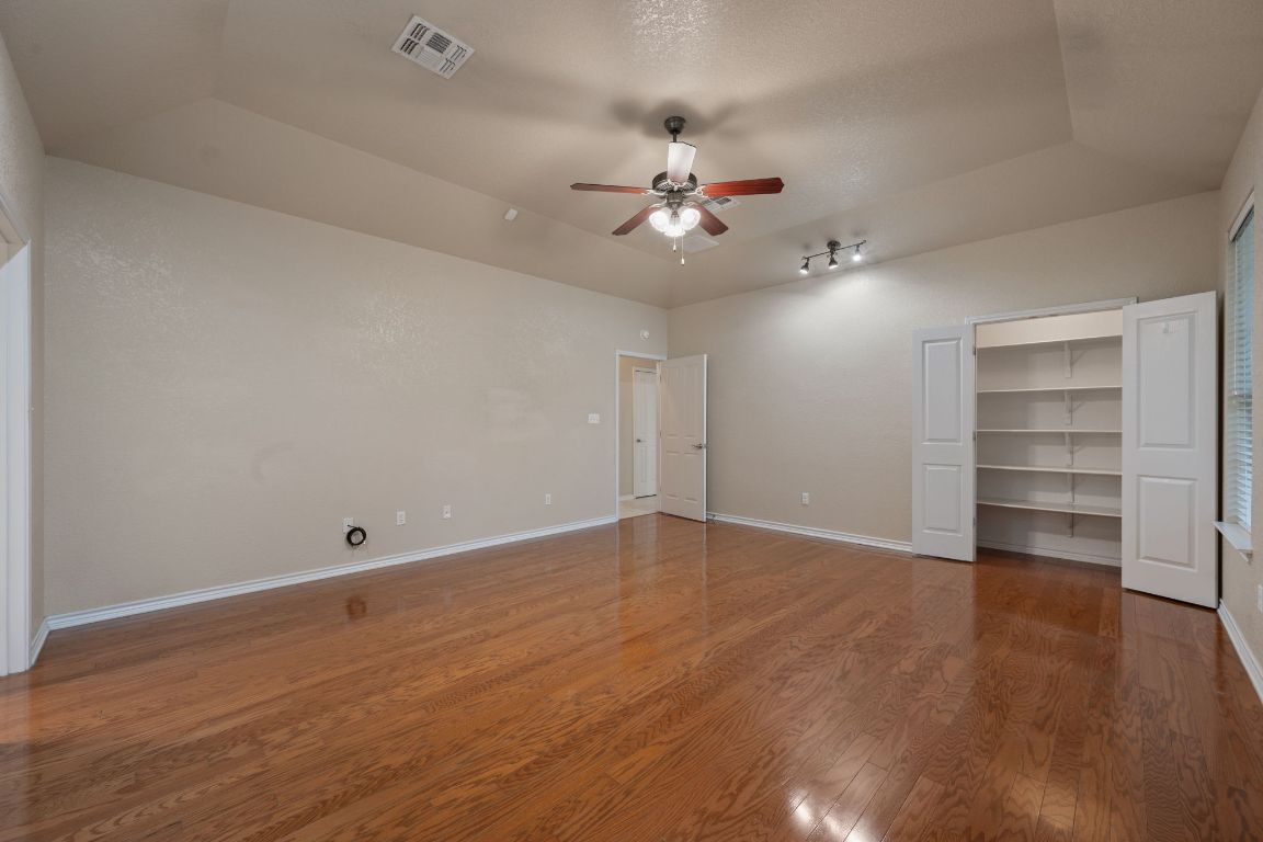 686 Benchmark Trail Belton, TX 76513 - Photo 13 of 38 a view of an empty room with a window and wooden floor