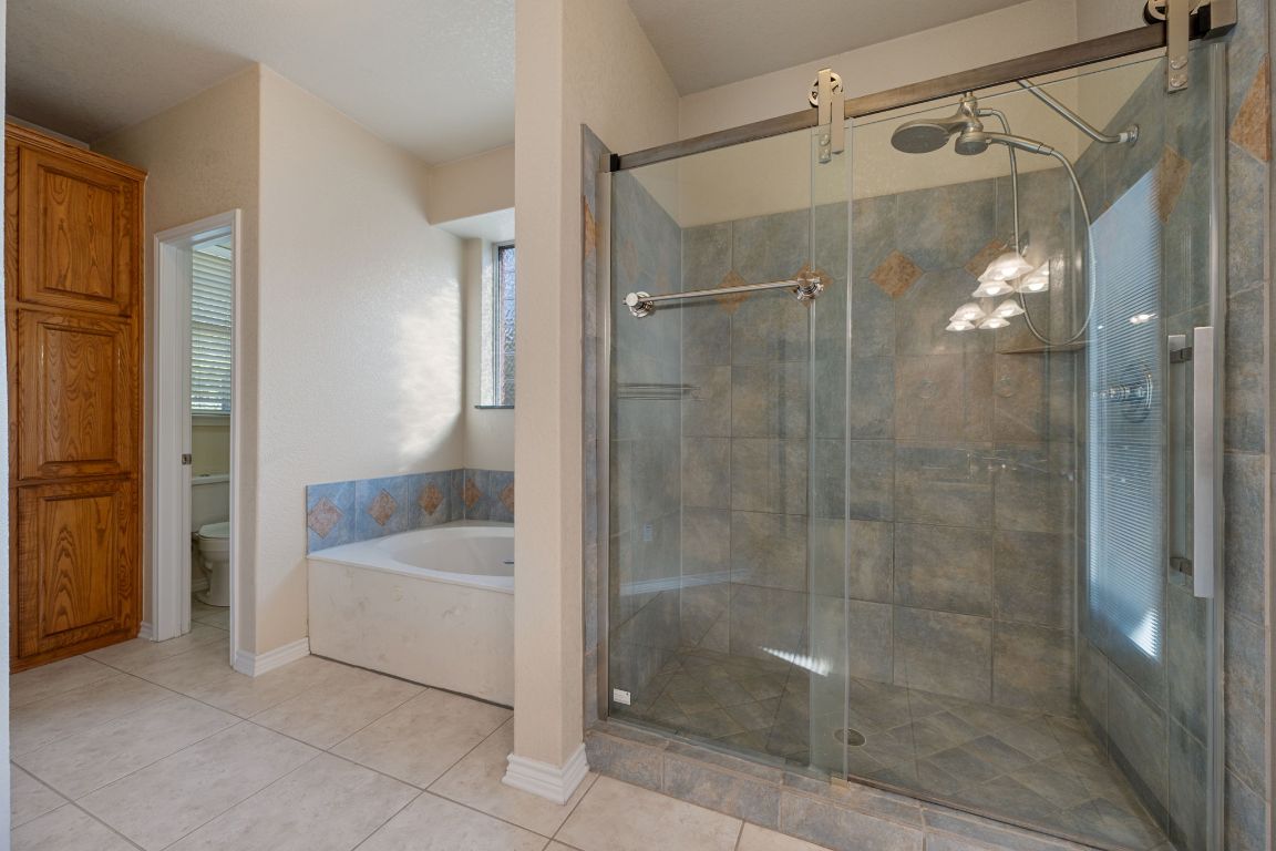 686 Benchmark Trail Belton, TX 76513 - Photo 15 of 38 a bathroom with a shower and a bathtub