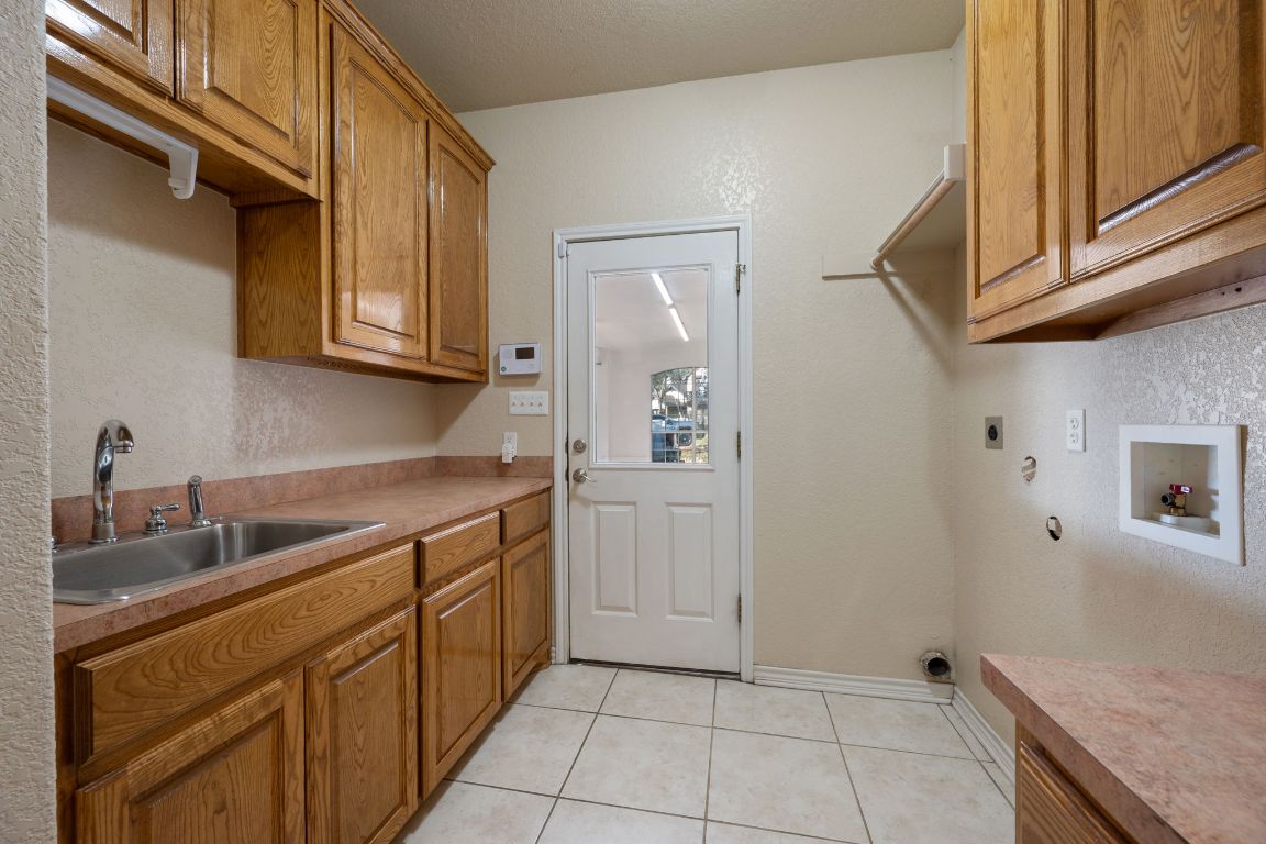 686 Benchmark Trail Belton, TX 76513 - Photo 19 of 38 a kitchen with a sink and cabinets