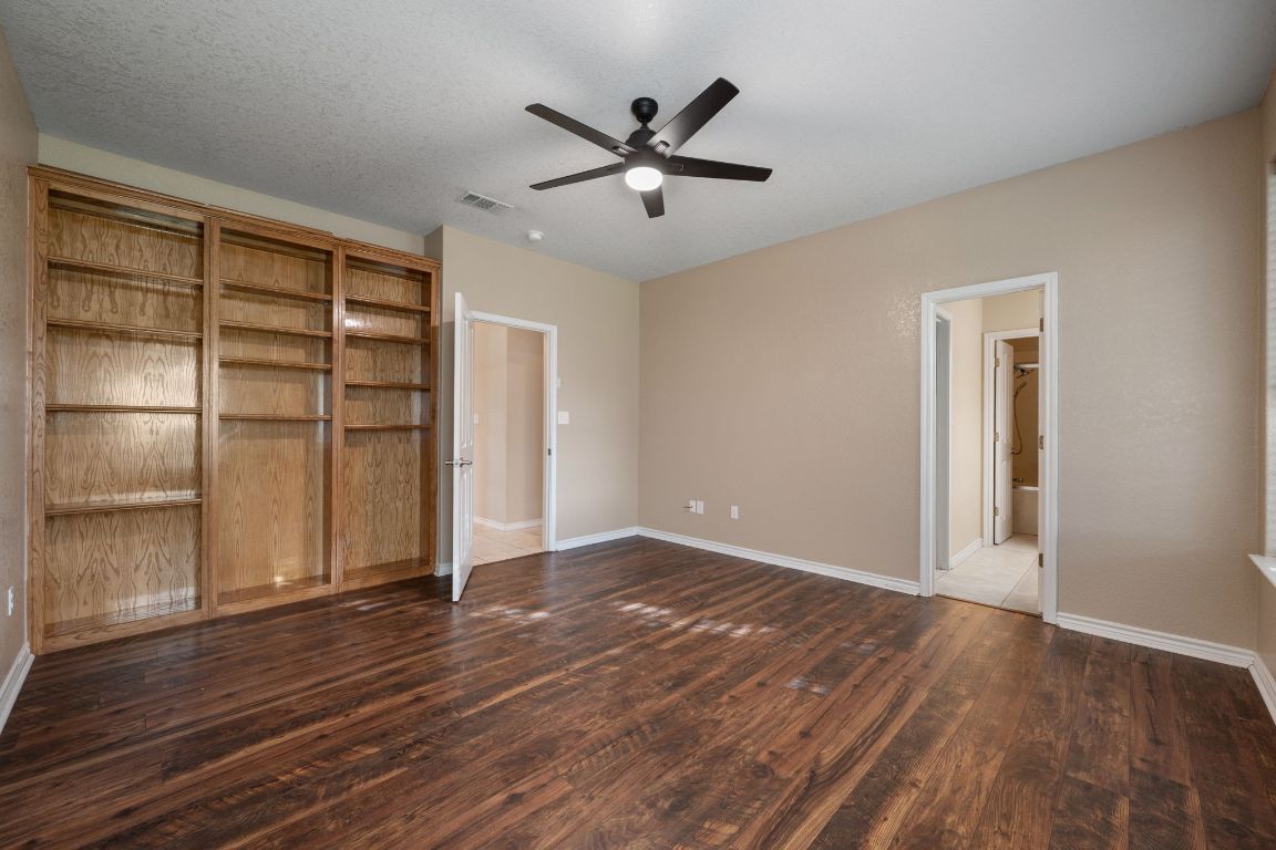 686 Benchmark Trail Belton, TX 76513 - Photo 21 of 38 an empty room with wooden floor closet and windows