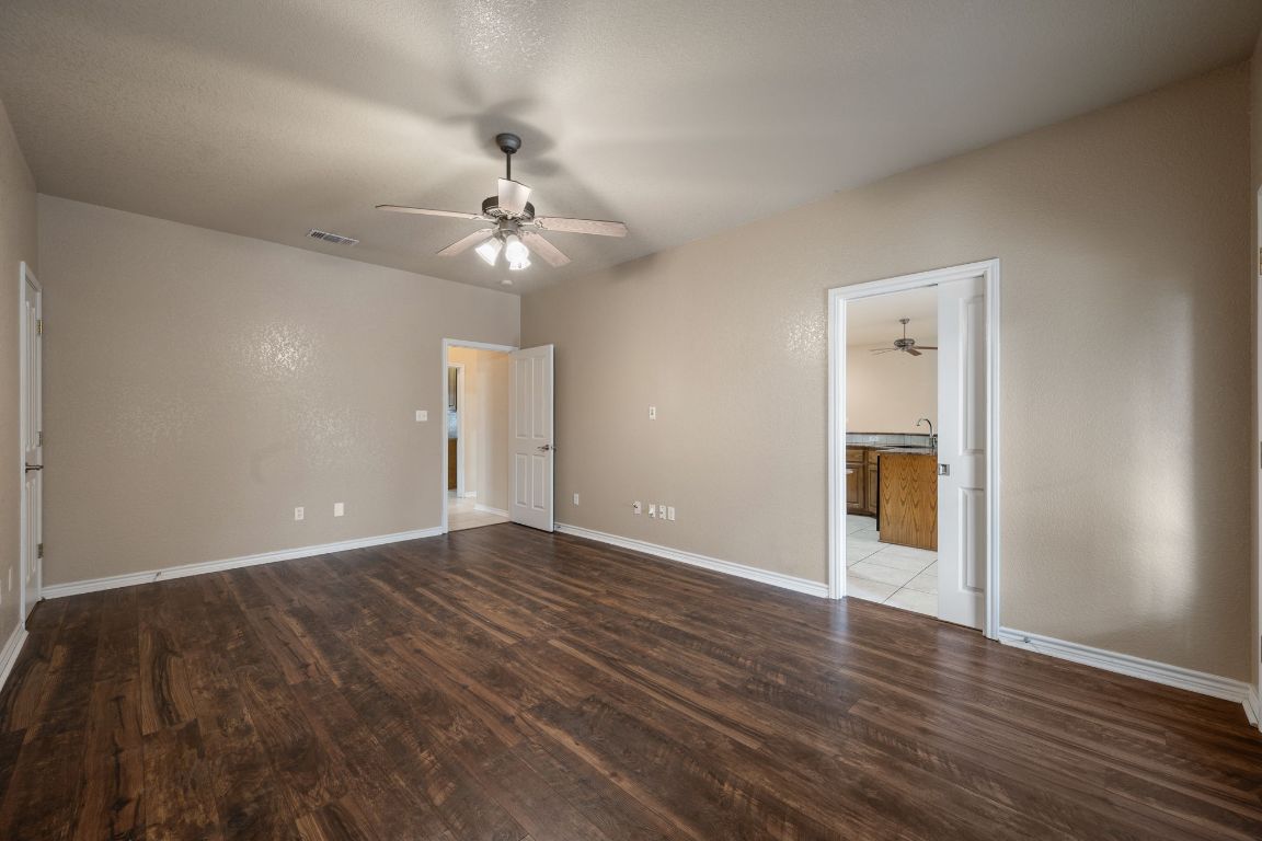 686 Benchmark Trail Belton, TX 76513 - Photo 25 of 38 a view of an empty room with wooden floor