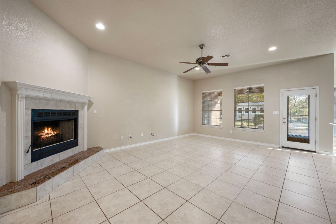 686 Benchmark Trail Belton, TX 76513 - Photo 5 of 38 a view of an empty room with a fireplace and a window