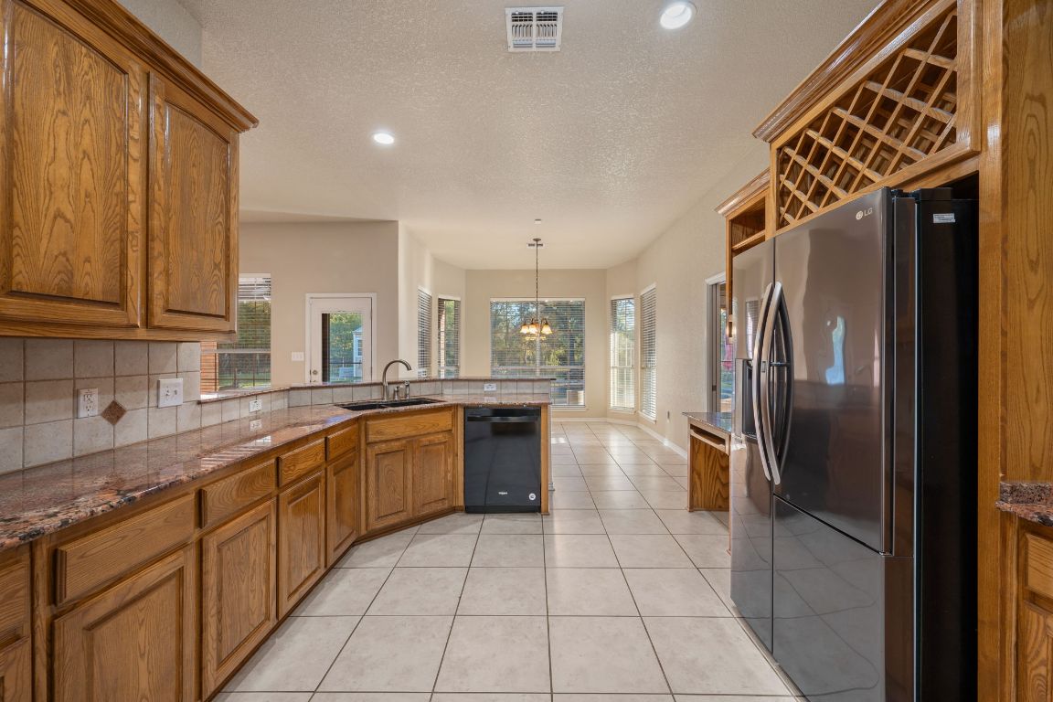 686 Benchmark Trail Belton, TX 76513 - Photo 8 of 38 a kitchen with stainless steel appliances granite countertop a refrigerator and a sink