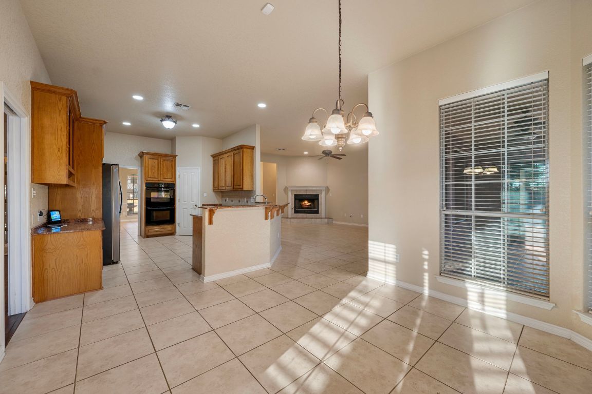 686 Benchmark Trail Belton, TX 76513 - Photo 9 of 38 a view of a kitchen with refrigerator and a living room view
