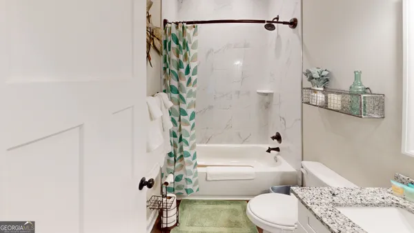 a bathroom with a bathtub shower sink and toilet