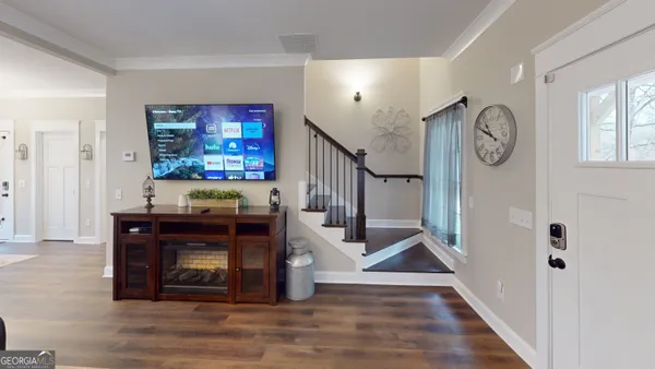 a view of entryway livingroom and hall with wooden floor