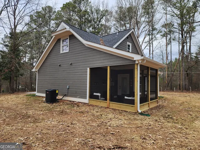 a backyard of a house with barbeque oven and brick wall