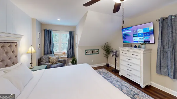 a bedroom with a bed and flat screen tv