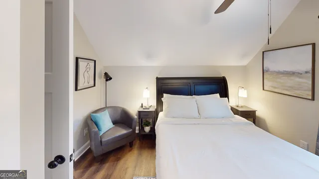 a bedroom with a bed couch and a mirror