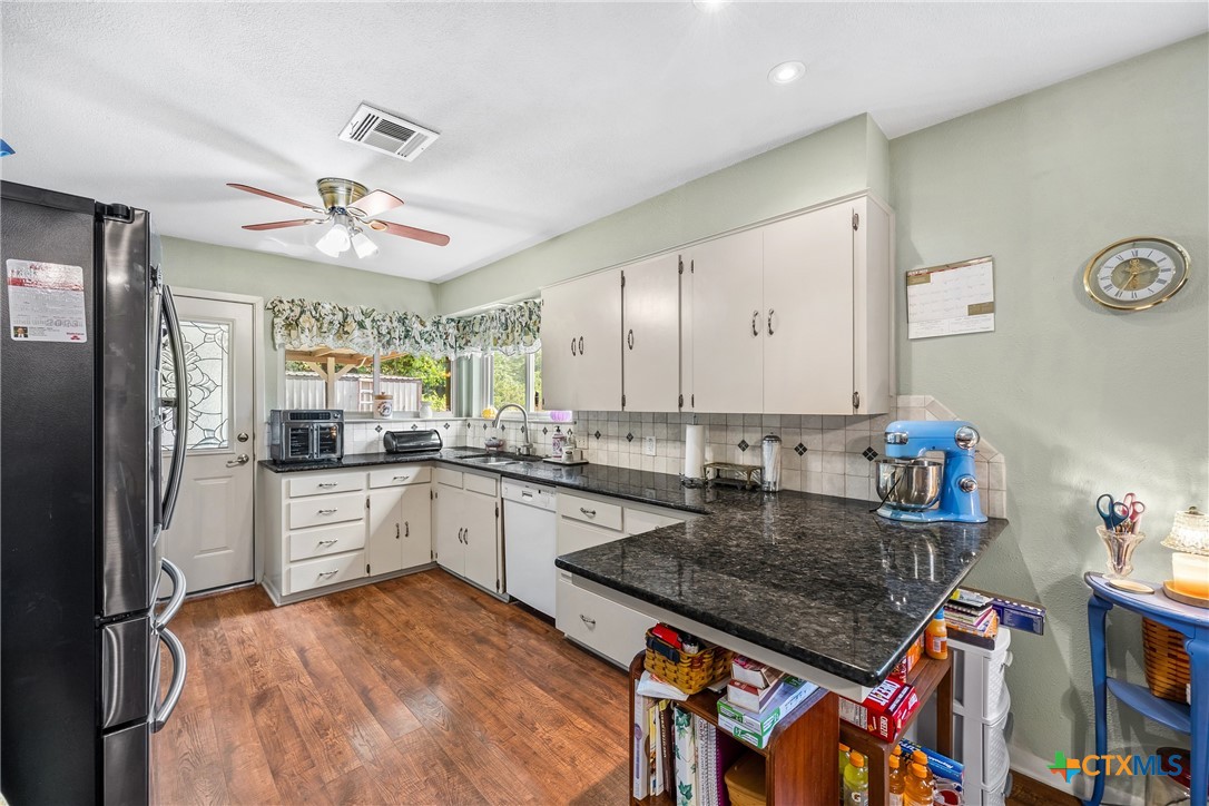 3909 Fairway Drive Temple, TX 76502 - Photo 7 of 24 a kitchen with stainless steel appliances granite countertop a stove refrigerator and a sink