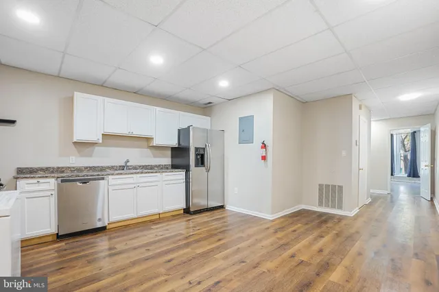 a kitchen with stainless steel appliances granite countertop a refrigerator and a stove