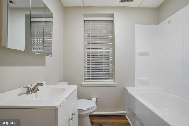 a bathroom with a sink mirror and toilet