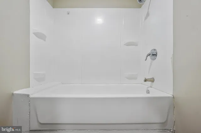 a view of a room with wooden floor and windows